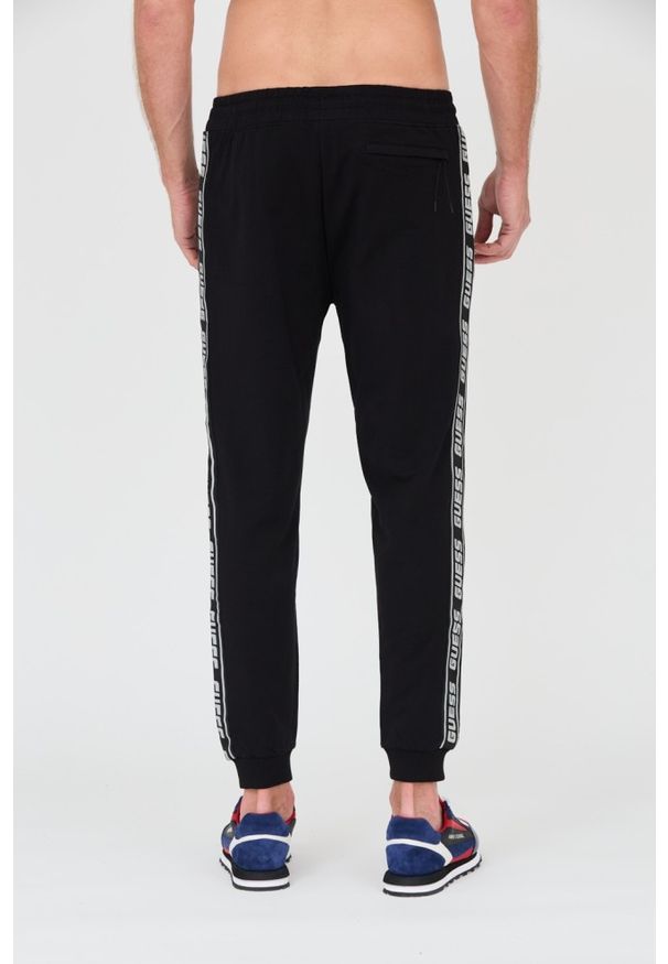 Guess - GUESS Czarne męskie spodnie dresowe, Rozmiar S. Kolor: czarny. Materiał: dresówka