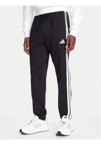 Adidas - adidas Spodnie dresowe Essentials 3-Stripes JE6430 Czarny Regular Fit. Kolor: czarny. Materiał: bawełna #1