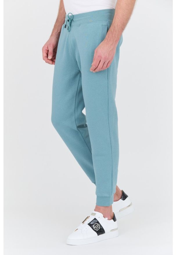Guess - GUESS Turkusowe męskie spodnie dresowe Aldwin, Rozmiar XL. Kolor: niebieski. Materiał: dresówka