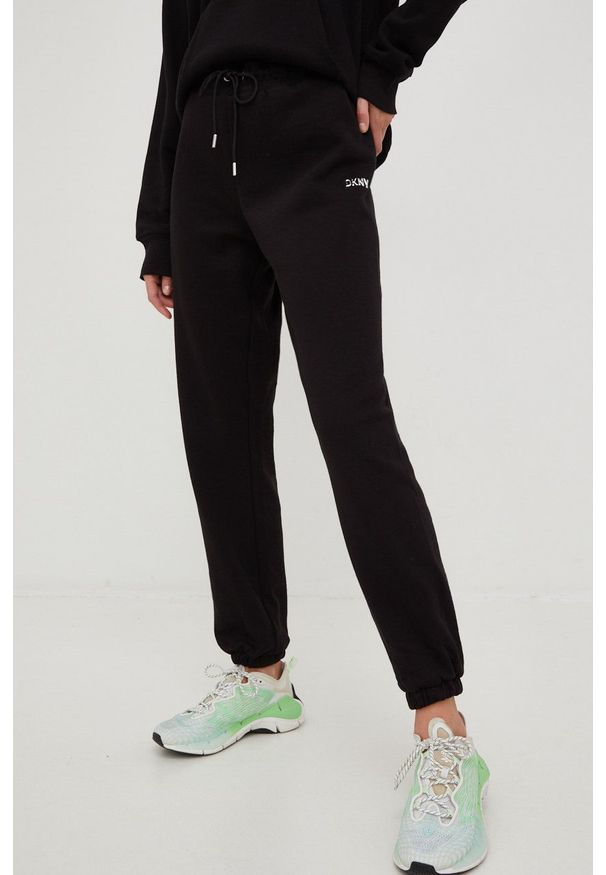 DKNY - Dkny spodnie dresowe damskie kolor czarny gładkie. Kolor: czarny. Materiał: dresówka. Wzór: gładki