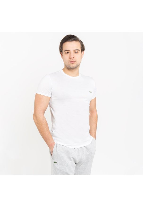 Koszulka męska Lacoste (TH2038-001). Typ kołnierza: polo. Kolor: biały. Materiał: dzianina. Długość: krótkie. Sezon: lato. Sport: bieganie