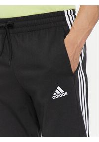 Adidas - adidas Spodnie dresowe Essentials Single Jersey Tapered Open Hem 3-Stripes Joggers IC0044 Czarny Regular Fit. Kolor: czarny. Materiał: bawełna #5