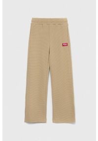 Fila spodnie dresowe dziecięce kolor beżowy gładkie. Stan: podwyższony. Kolor: beżowy. Materiał: dresówka. Wzór: gładki #1