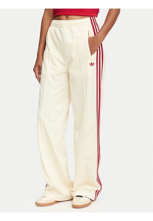 Adidas - adidas Spodnie dresowe Firebird Loose Tracksuit KS4671 Kremowy Loose Fit. Kolor: kremowy. Materiał: syntetyk
