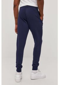 New Balance - Spodnie. Kolor: niebieski. Materiał: bawełna, poliester, dzianina. Wzór: gładki #3