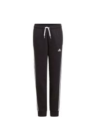 Adidas - Spodnie dla dzieci adidas Essentials 3 Stripes Pant czarne GQ8897. Kolor: biały, czarny, wielokolorowy. Wzór: paski. Sport: bieganie