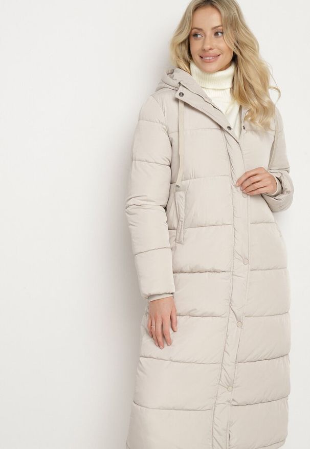 Born2be - Jasnobeżowa Pikowana Kurtka o Długim Kroju z Kapturem i Ściągaczami przy Rękawach Sassira. Okazja: na spacer, na co dzień. Typ kołnierza: kaptur. Kolor: beżowy. Materiał: jeans. Długość: długie. Styl: casual, elegancki