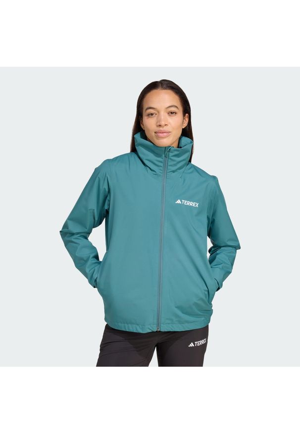 Adidas - Kurtka Multi Essentials 2L Rain. Kolor: niebieski. Technologia: ClimaProof (Adidas). Sport: turystyka piesza