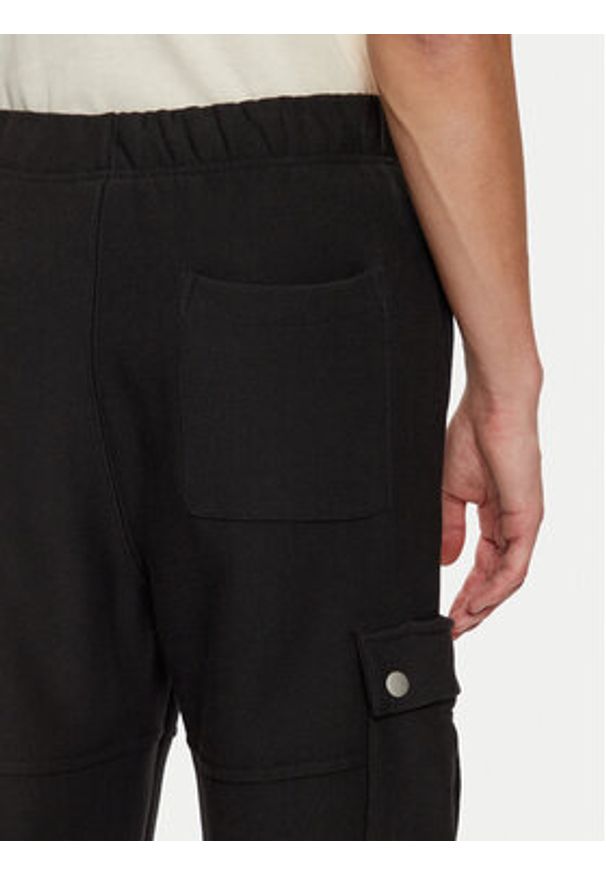 Champion Spodnie dresowe 220710 Czarny Loose Fit. Kolor: czarny. Materiał: bawełna