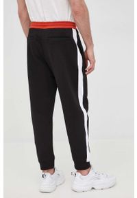 Armani Exchange spodnie dresowe bawełniane męskie kolor czarny z nadrukiem. Kolor: czarny. Materiał: bawełna, dresówka. Wzór: nadruk