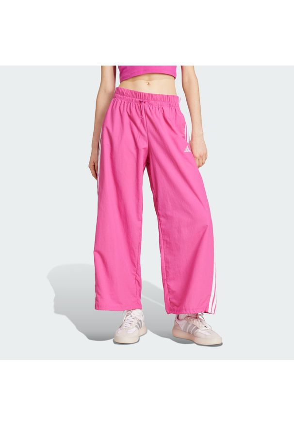 Adidas - Spodnie Essentials 3-Stripes Lifestyle Woven Parachute. Kolor: biały, wielokolorowy, różowy. Materiał: materiał