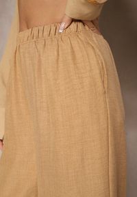 Renee - Ciemnobeżowe Spodnie Typu Palazzo High Waist o Szerokim Kroju Arathira. Okazja: na co dzień, na imprezę. Stan: podwyższony. Kolor: beżowy. Materiał: jedwab. Długość: długie. Styl: elegancki, casual
