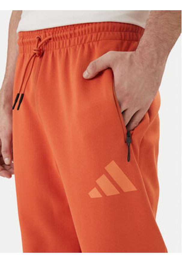 Adidas - adidas Spodnie dresowe Z.N.E. KE4686 Pomarańczowy Regular Fit. Kolor: pomarańczowy. Materiał: bawełna