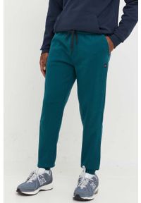 Rip Curl spodnie dresowe męskie kolor zielony gładkie. Kolor: zielony. Materiał: dresówka. Wzór: gładki