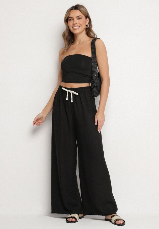 Born2be - Czarne Szerokie Spodnie z Bawełną i Wysokim Stanem Ozdobione Wiązaniem Laveldi. Okazja: na co dzień. Stan: podwyższony. Kolor: czarny. Materiał: bawełna. Wzór: aplikacja. Styl: casual, elegancki