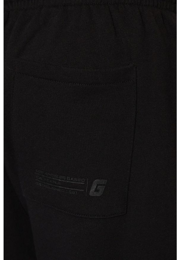 Guess - GUESS Czarne męskie spodnie dresowe Emis, Rozmiar XL. Kolor: czarny. Materiał: dresówka