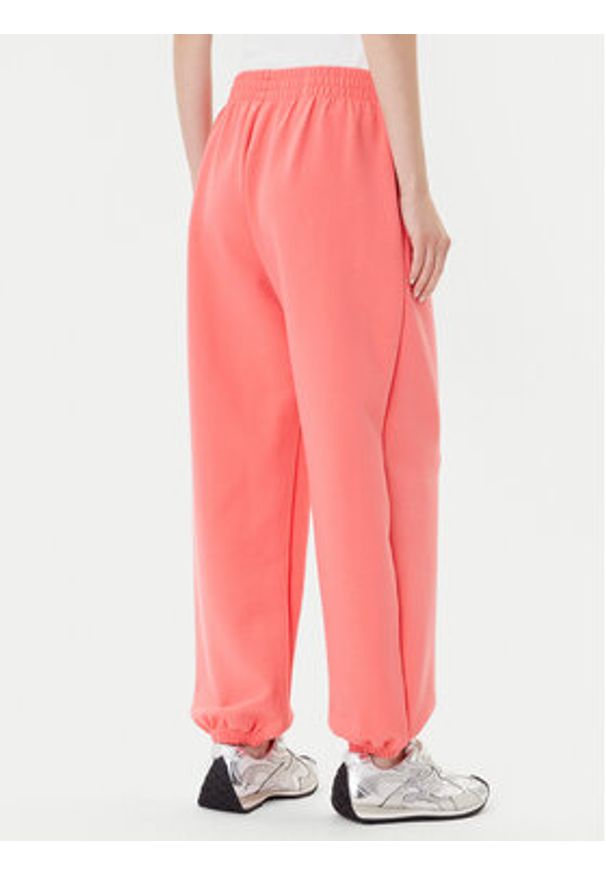 Adidas - adidas Spodnie dresowe ALL SZN Soft Lux lKD9773 Koralowy Loose Fit. Kolor: pomarańczowy. Materiał: syntetyk