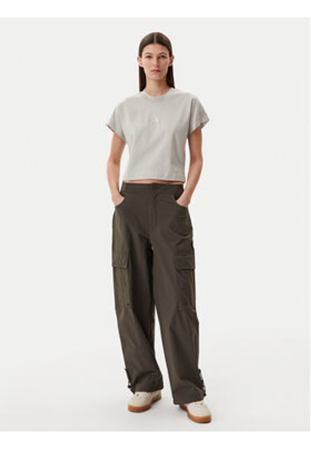 Adidas - adidas Spodnie materiałowe Premium Essentials JD4785 Khaki Loose Fit. Kolor: brązowy. Materiał: syntetyk