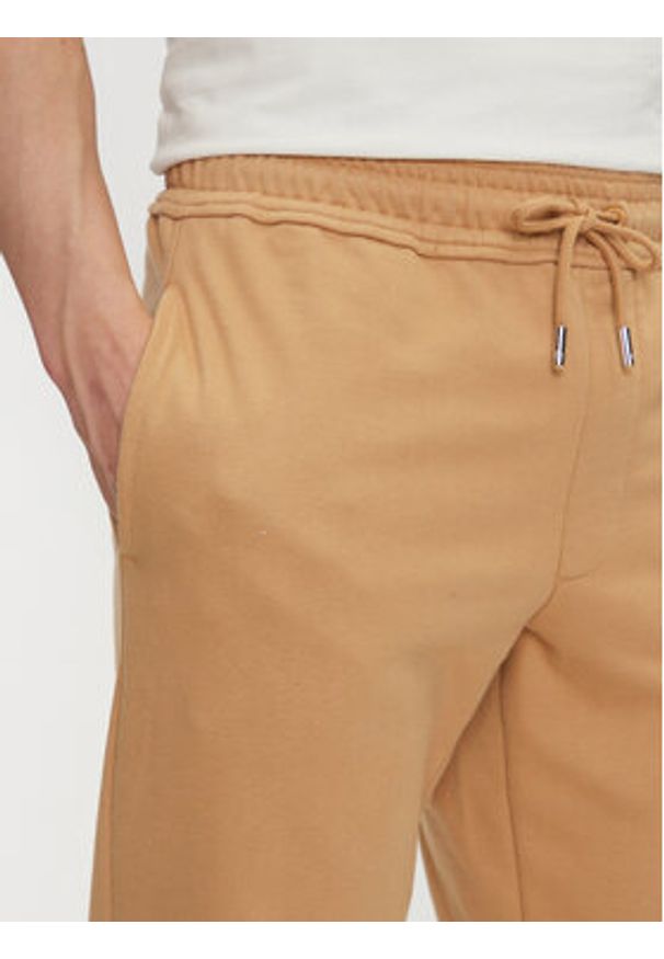 Timberland Spodnie dresowe TB0A5V5Q Beżowy Regular Fit. Kolor: beżowy. Materiał: bawełna