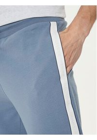 TOMMY HILFIGER - Tommy Hilfiger Spodnie dresowe UM0UM03013 Niebieski Regular Fit. Kolor: niebieski. Materiał: bawełna