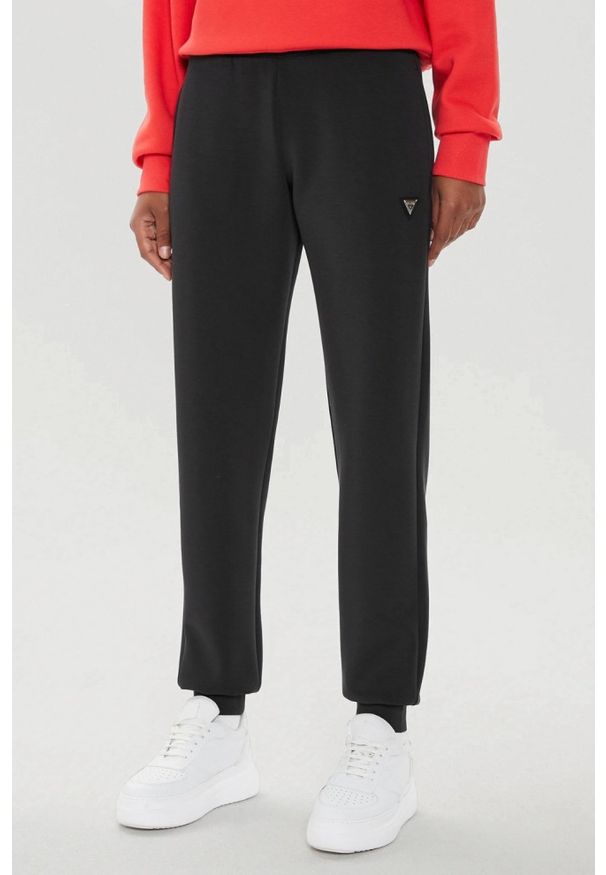 Guess - GUESS Czarne damskie spodnie dresowe Olympe, Rozmiar S. Kolor: czarny. Materiał: dresówka