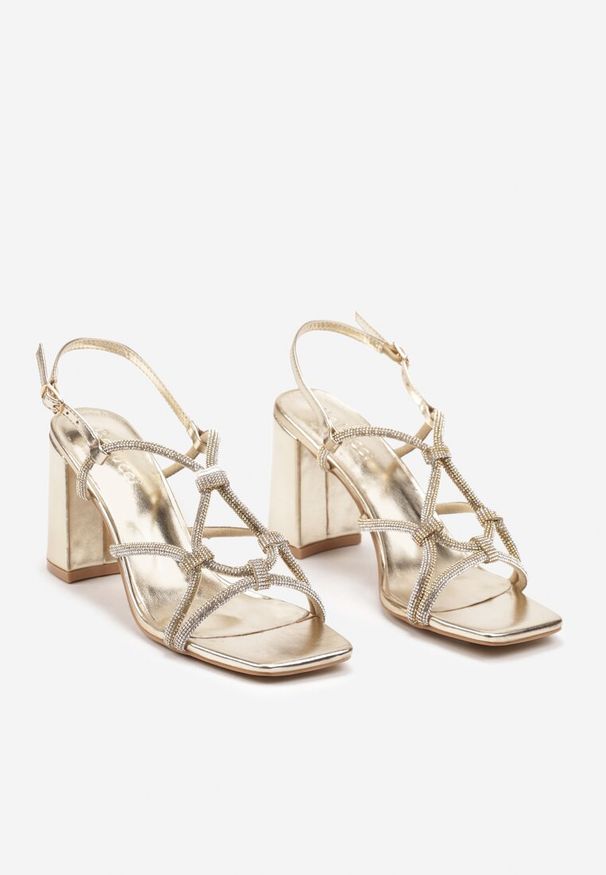 Renee - Złote Sandały na Obcasie z Cyrkoniami Zapinane Wokół Kostki Chrisstana. Kolor: złoty. Materiał: jeans. Obcas: na obcasie. Styl: elegancki. Wysokość obcasa: średni