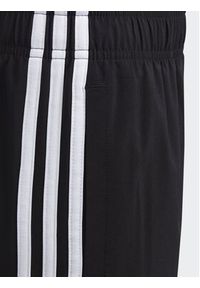 Adidas - adidas Spodnie dresowe Essentials 3-Stripes Woven Tracksuit Bottoms HR6334 Czarny Slim Fit. Kolor: czarny. Materiał: syntetyk #4