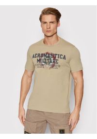 Beżowy t-shirt z nadrukiem Aeronautica Militare. Kolor: beżowy. Materiał: elastan, bawełna. Wzór: nadruk
