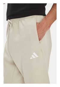 Adidas - adidas Spodnie dresowe Future Icons 3-Stripes JW7092 Beżowy Regular Fit. Kolor: beżowy. Materiał: bawełna #5