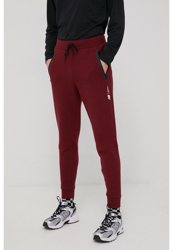 New Balance spodnie dresowe MP11143GTH męskie kolor bordowy melanżowe. Kolor: czerwony. Materiał: dresówka. Wzór: melanż