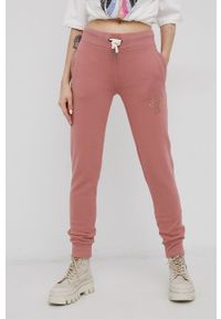 Superdry - Spodnie. Kolor: różowy. Wzór: nadruk