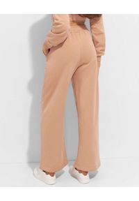 THECADESS - Beżowe spodnie dresowe Lorin. Kolor: beżowy. Materiał: dresówka #4