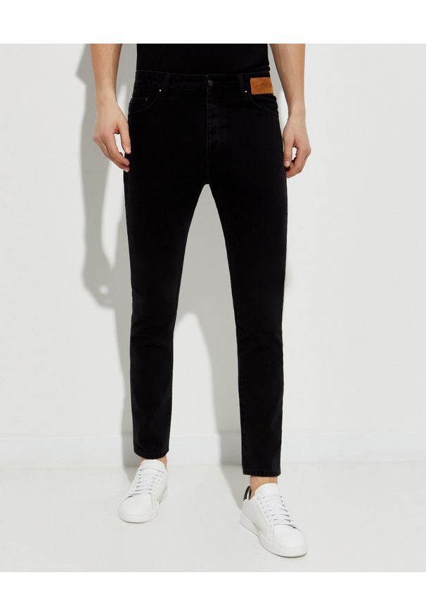 PALM ANGELS - Czarne jeansy z logo. Kolor: czarny. Długość: długie. Wzór: aplikacja, nadruk. Styl: klasyczny
