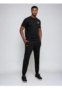 Sinsay - Spodnie dresowe regular fit Batman - czarny. Kolor: czarny. Materiał: dresówka. Wzór: motyw z bajki #1