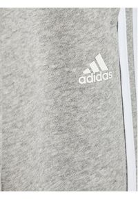 Adidas - adidas Spodnie dresowe Essentials H65793 Szary Standard Fit. Kolor: szary. Materiał: bawełna