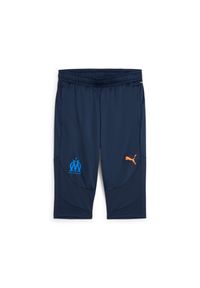 Puma - Spodnie treningowe 3/4 OM 2024/25. Kolor: wielokolorowy, niebieski, pomarańczowy. Sport: piłka nożna #1