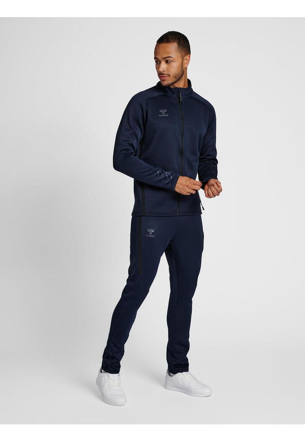 Bluza dresowa zapinana na zamek błyskawiczny Hummel Cima XK. Kolor: niebieski. Materiał: dresówka. Wzór: nadruk. Sport: piłka ręczna