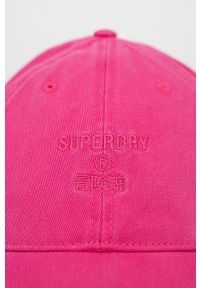 Superdry czapka bawełniana kolor różowy gładka. Kolor: różowy. Materiał: bawełna. Wzór: gładki
