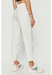 Reebok - Spodnie. Kolor: biały. Materiał: wiskoza, dzianina, elastan, nylon, poliester. Wzór: gładki #2