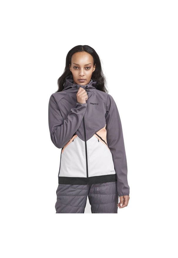 Damska wiatrówka z kapturem Craft Glide. Typ kołnierza: kaptur. Kolor: szary. Materiał: softshell. Sport: turystyka piesza