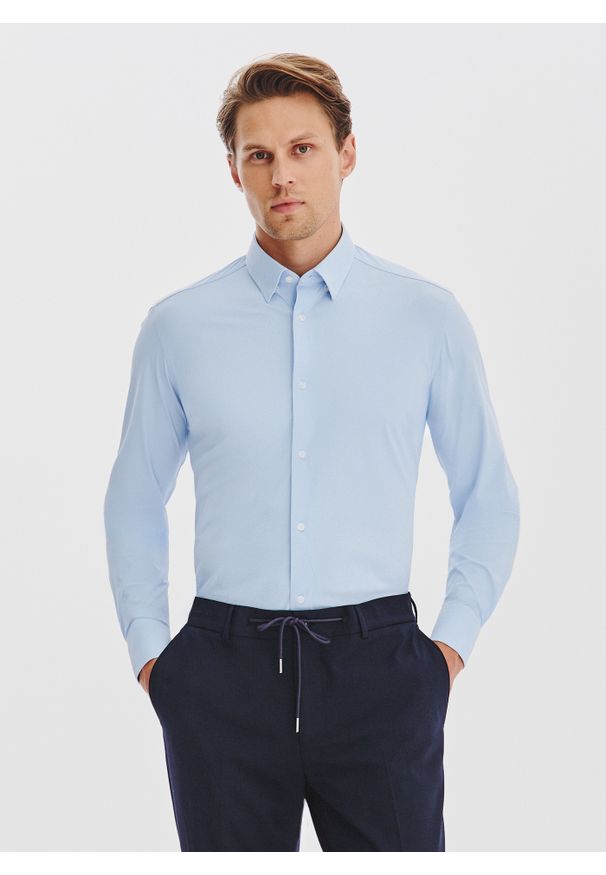 Pako Lorente - PAKO LORENTE – Niebieska dzianinowa koszula męska. Typ kołnierza: kołnierzyk klasyczny. Kolor: niebieski, czarny. Materiał: dzianina. Długość rękawa: długi rękaw. Długość: długie. Wzór: gładki. Styl: klasyczny