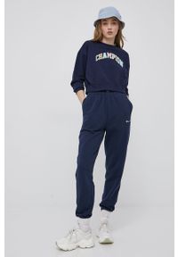 Champion spodnie 217404 kolor granatowy z aplikacją. Kolor: niebieski. Materiał: włókno, dzianina, materiał. Wzór: aplikacja #5
