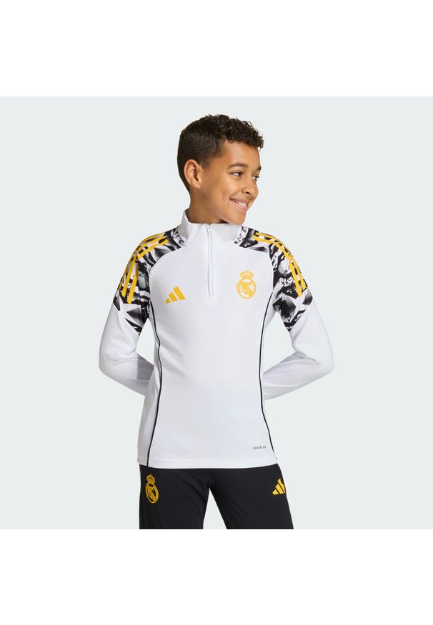 Adidas - Dziecięca bluza dresowa adidas Real Madrid Avengers 25/26 Tiro25 Competition. Kolor: żółty, biały, wielokolorowy. Materiał: dresówka. Wzór: motyw z bajki. Styl: sportowy