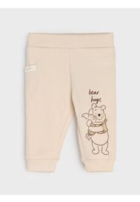 Sinsay - Spodnie z polarem w środku Winnie the Pooh - beżowy. Kolor: beżowy. Materiał: polar