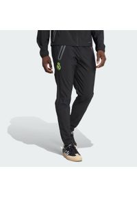 Adidas - Spodnie Real Madrid Tiro 25 Pro Vis Tech Travel. Kolor: czarny, wielokolorowy, żółty. Sport: piłka nożna