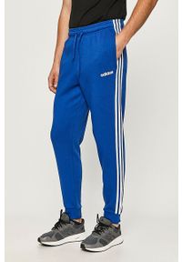 Adidas - adidas - Spodnie. Kolor: niebieski. Materiał: bawełna, poliester, dzianina. Wzór: nadruk, aplikacja #1
