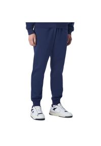 Spodnie Champion Tonal C Logo Fleece Joggers 220314-BS561 - granatowe. Kolor: niebieski. Materiał: bawełna, poliester, materiał, dresówka. Wzór: haft