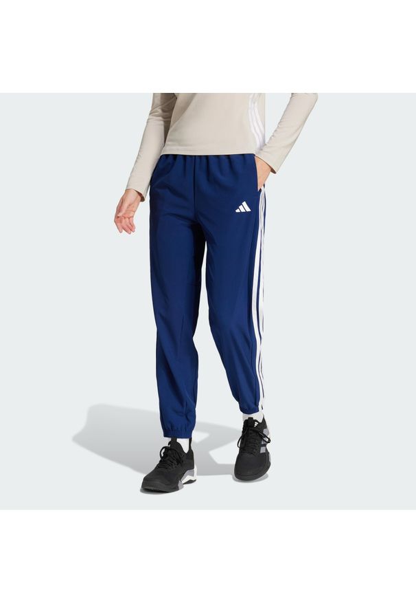 Adidas - Spodnie Train Essentials 3-Stripes Woven. Kolor: biały, niebieski, wielokolorowy. Materiał: materiał. Technologia: ClimaCool (Adidas). Sport: fitness