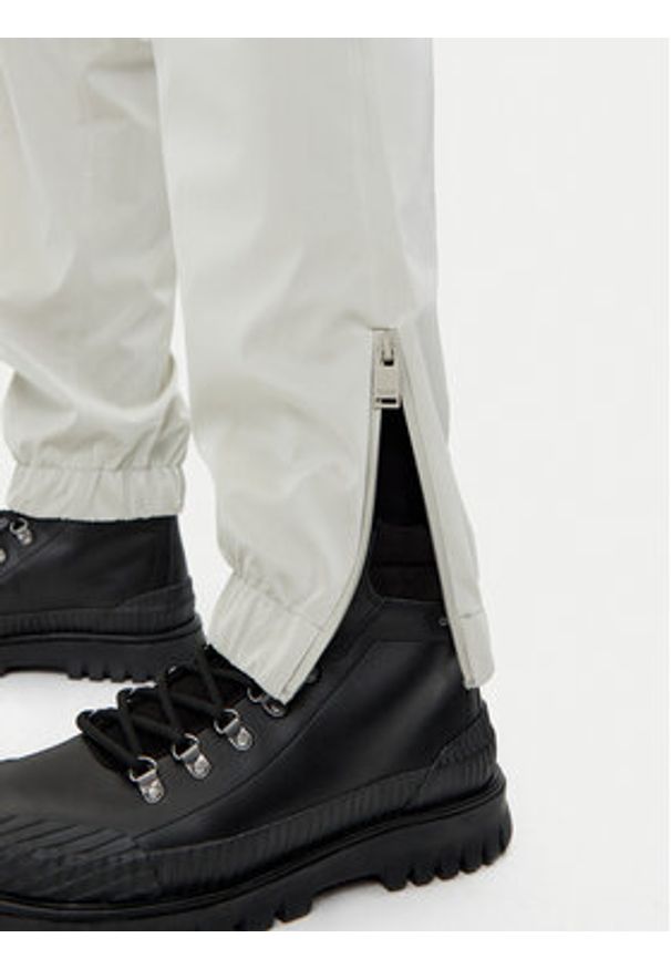 Rains Spodnie przeciwdeszczowe Unisex 18560 Beżowy Regular Fit. Kolor: beżowy. Materiał: syntetyk