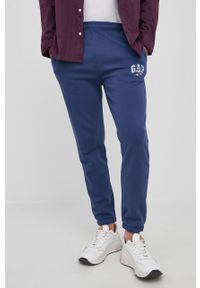 GAP spodnie x Disney męskie z nadrukiem. Kolor: niebieski. Wzór: nadruk, motyw z bajki